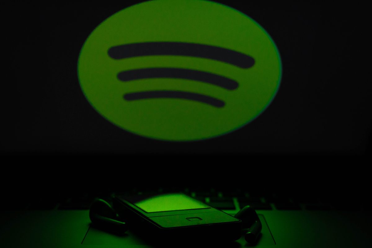 Il logo di Spotify su uno schermo di un computer illumina un cellulare