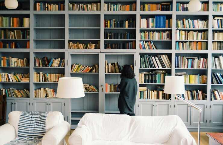 Donna davanti alla libreria di casa